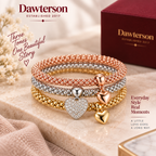 Three-Tone Heart Charm Bracelet set styled in a warm lifestyle setting